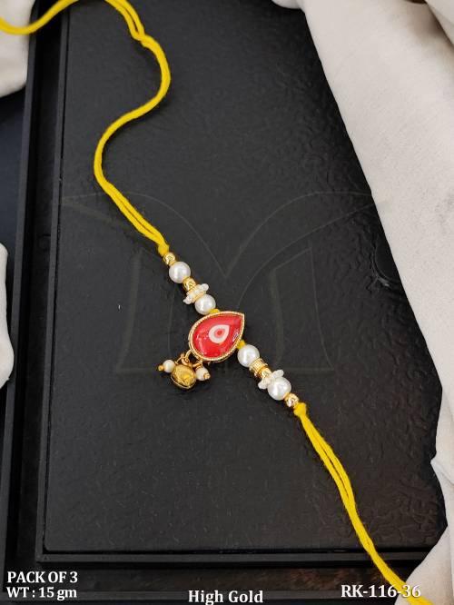High Gold Pearl Rakhi with Red Kundan Stone